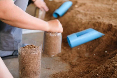 Putting soil in bags as part of steam sterilization